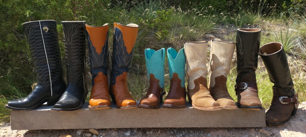a row of 5 pair of custom-made boots made by Guy Spikes and Paul Bonds. All leather, hand-crafted boots