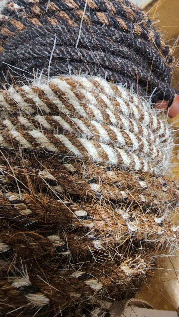 brown, black and white horse hair mecates that are hand woven, used with a rein for a horse