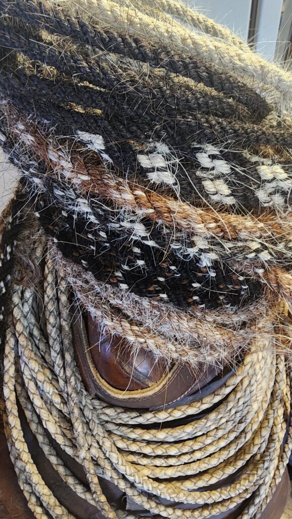 black and white horse hair mecates that are hand woven, used with a rein for a horse